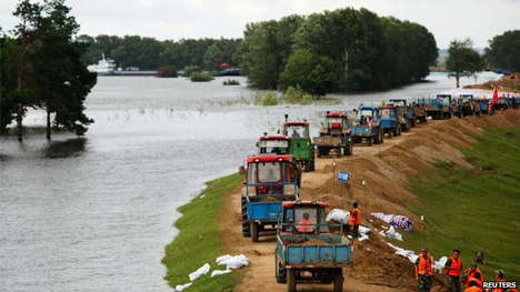 Farmers working to strengthen flood defences.