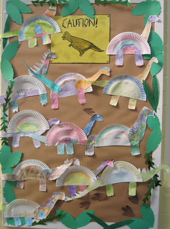 Children make a dinosaur themed display.