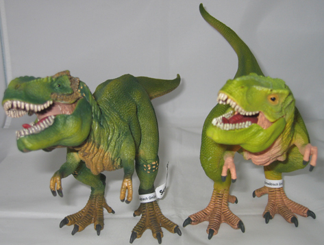 A pair of Schleich T. rex dinosaur models.