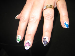 Dinosaur themed nail designs.