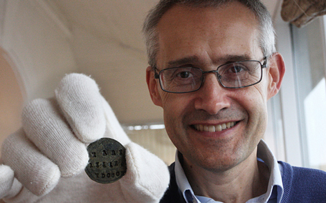 David Tucker, the Director of Lyme Regis Museum with the Anning token.