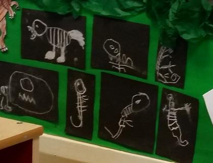 Learning about dinosaurs - chalk drawings.