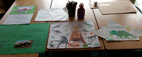 Year 2 children and their dinosaur posters.