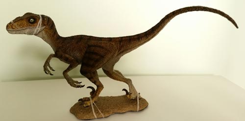 A 1:18 scale Velociraptor dinosaur model (Rebor Winston).