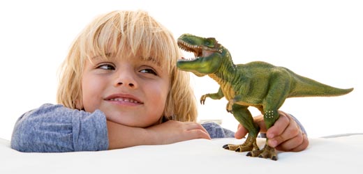 Tyrannosaurus rex model and a young dinosaur fan.