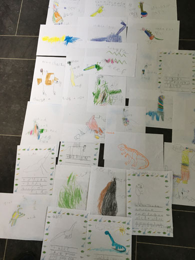 'Reception class letters and dinosaur drawings.