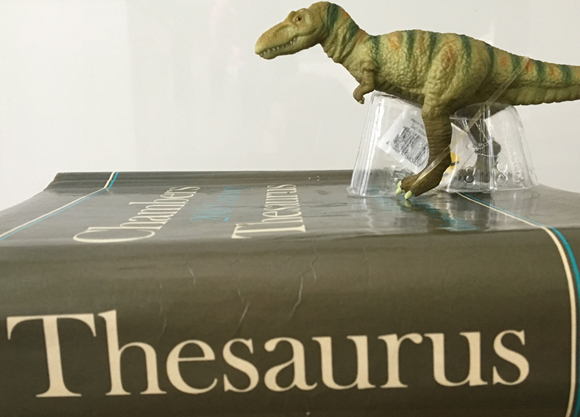 Thesaurus and a dinosaur (Tarbosaurus dinosaur model).