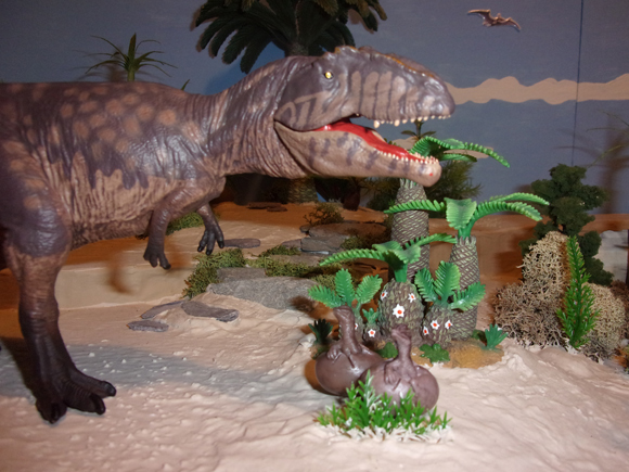 A Giganotosaurus mother stands guard over her hatchlings.