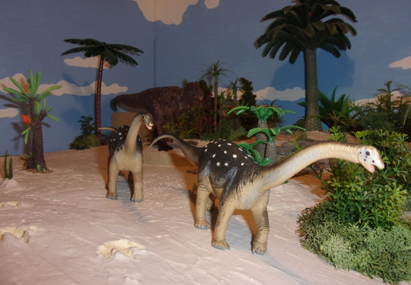 Two Sauropods being stalked by Giganotosaurus.