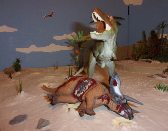 T. rex feasts on a Triceratops.