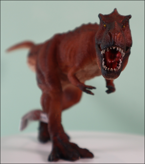 The Mojo Fun T. rex Deluxe dinosaur model approaches.