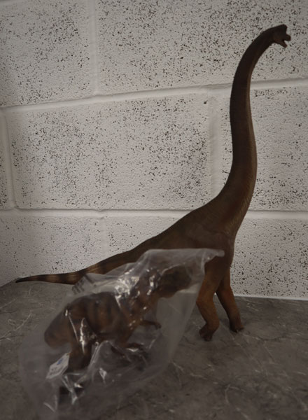 A W-Dragon Giraffatitan model towers over a Papo standing T. rex figure.