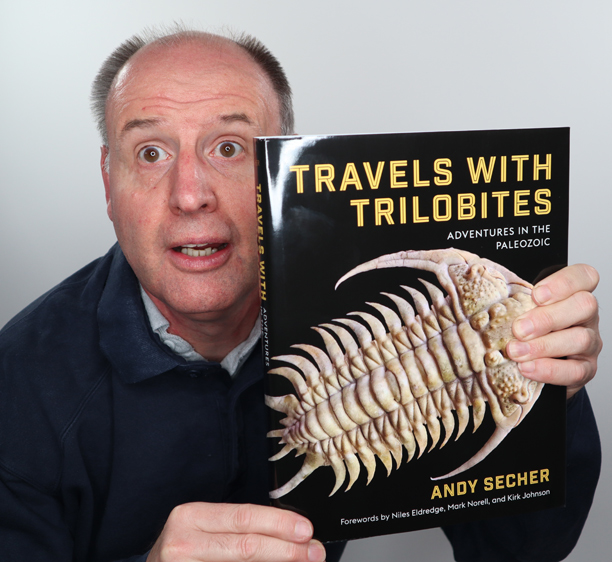 Holding the "Travels with Trilobites" book.