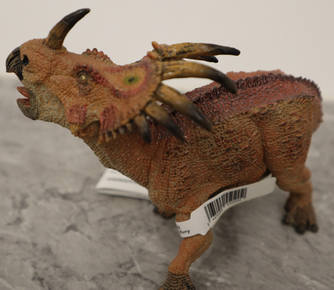 Papo red Styracosaurus dinosaur model.