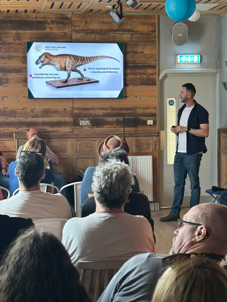 Dr Dean Lomax presenting how to build a dinosaur.