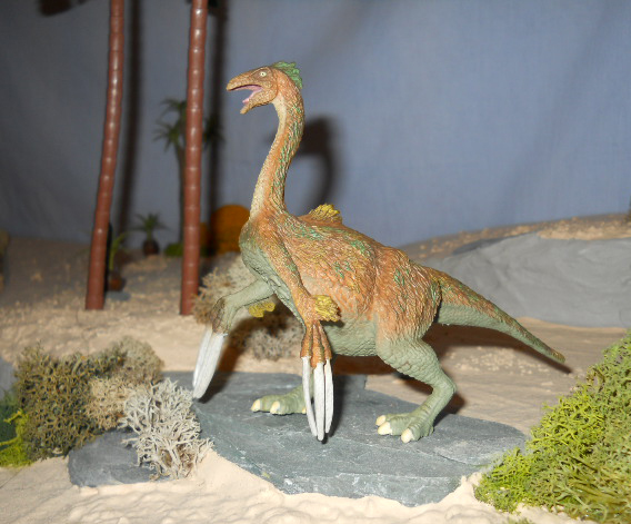 CollectA Therizinosaurus model in a prehistoric animal diorama.
